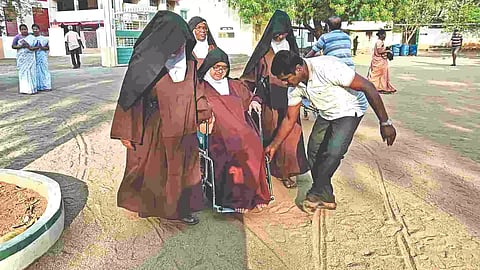 A wheel-chair bound voter reaching a polling centre