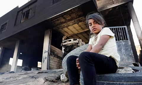 &nbsp;A Palestinian girl sits in front of her house after Israeli settlers attacked the village of al-Mughayyer, in the Israeli-occupied West Bank (Reuters)