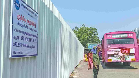 Commuters waiting at bus stand under scorching sun
