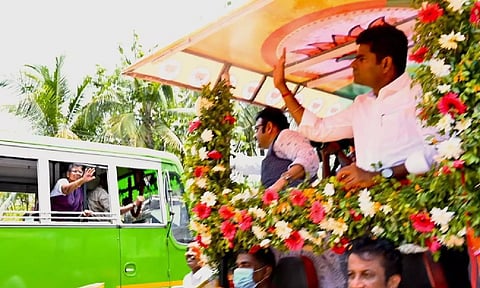 BJP state president K Annamalai waiving to a woman in a bus while campaigning for Kollam BJP candidate recently&nbsp;