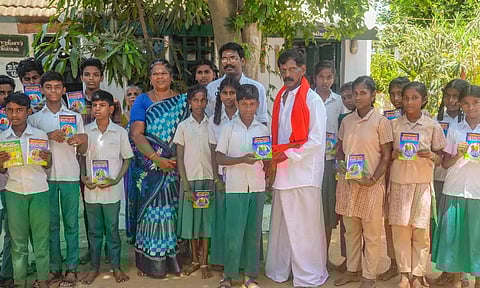 Haja Moideen distributing books to students on Tuesday (File)
