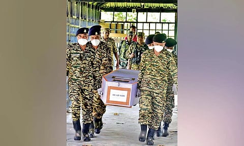Members of Central Reserve Police Force carry a coffin containing the body of their colleague in Imphal