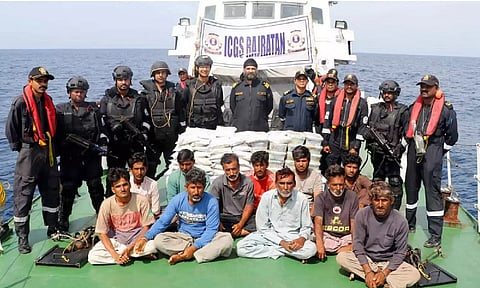 Indian Coast Guard (ICG) personnel with 14 crew members of a Pakistani boat after apprehending them from Indian waters (Photo: PTI)