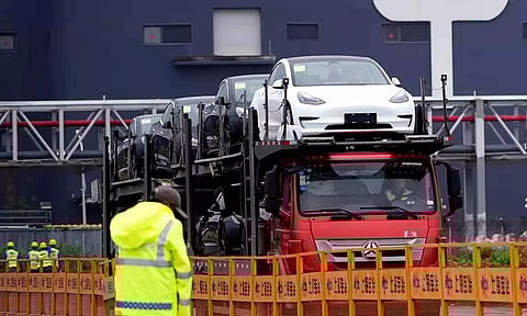 &nbsp;A truck transports new Tesla cars at its factory in Shanghai (Reuters)