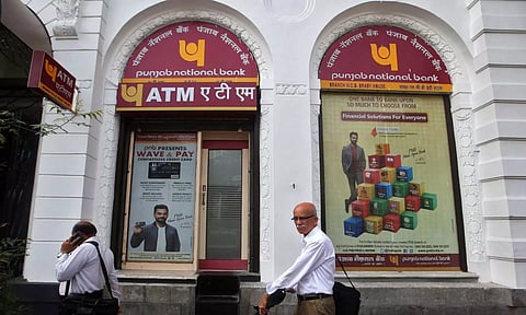 People walk past Punjab National Bank's Brady House branch in Mumbai&nbsp;