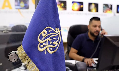 An employee works inside the office of the Qatar-based Al-Jazeera network in Jerusalem (Reuters)