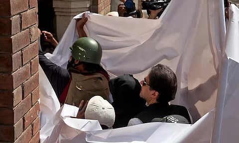 &nbsp;Imran Khan and his wife Bushra Bibi are covered with a white sheet(Image: Reuters)&nbsp;