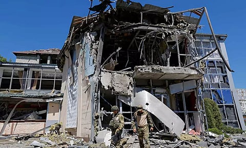 Russian military investigators work in a restaurant building hit by recent shelling (Reuters)