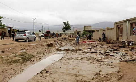 People clear damages caused in the aftermath of floods following heavy rain, in Sheikh Jalal District, Baghlan province (Reuters)