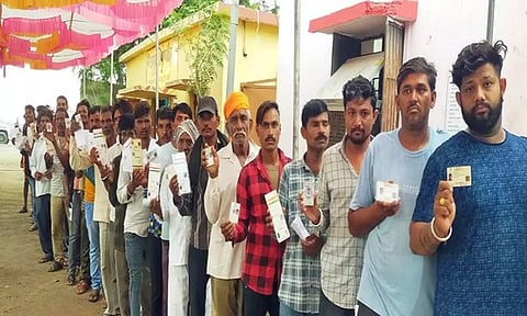 Voters wait in queue to cast their vote at Talun Khurd in Barwani