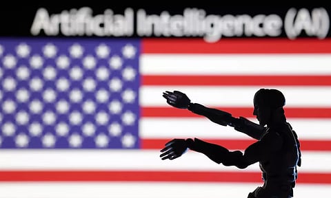 AI Artificial intelligence words, miniature of robot and U.S. flag are seen in this illustration taken December 21, 2023 (Reuters)