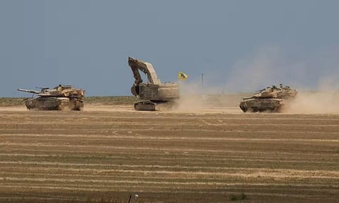 Israeli tanks manoeuvre, amid the ongoing conflict between Israel and the Palestinian Islamist group Hamas (Reuters)