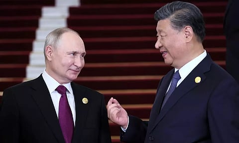 Russian President Vladimir Putin is welcomed by Chinese President Xi Jinping during a ceremony at the Belt and Road Forum in Beijing (Reuters)