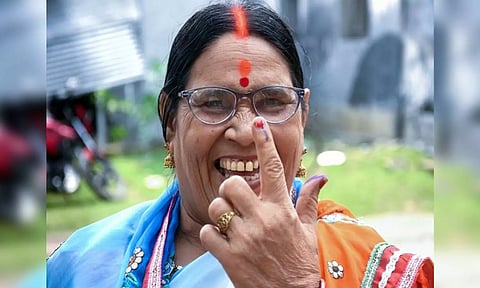 A woman voter shows her ink-marked finger after casting her vote in Asansol (ANI)