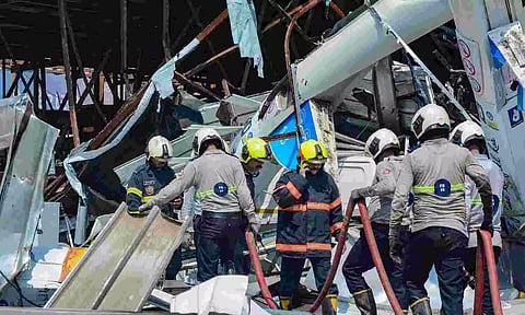 View of the site of the hoarding collapse, that is being cooled by the fire brigade personnel (PTI)