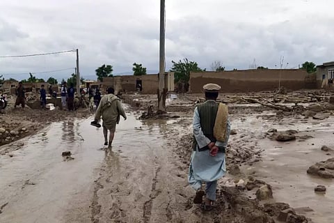 People seen near their damaged houses in Baghlan province in northern Afghanistan after heavy flooding, on May 11 2024 | Photo: AP
