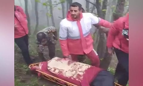 Rescue workers carry bodies of victims of May 19 helicopter crash in which Iran President Raisi died. (Press TV)