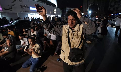 People pray for President Ebrahim Raisi in a ceremony at Vali-e-Asr square in downtown Tehran, Iran (AP)