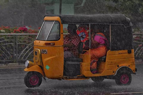 A visual of people travelling in the rains in Chennai. (Photo | Justin George/DT Next)