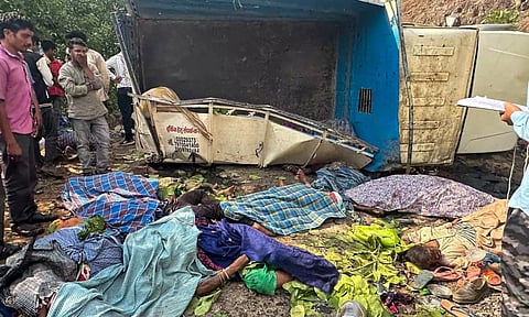 Locals near the site of an accident where a mini goods vehicle plunged into a gorge (PTI)