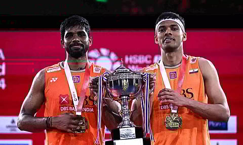 Satwiksairaj Rankireddy (L) and Chirag Shetty pose with the Thailand Open championship