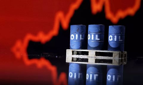 Model of Oil barrels are seen in front of rising stock graph in this illustration (Reuters)