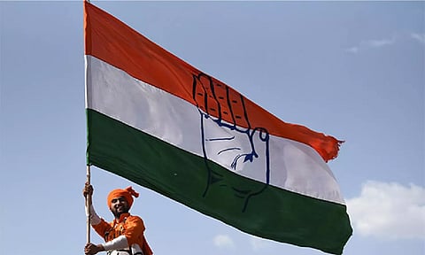 Congress worker holding party flag (Photo: ANI)