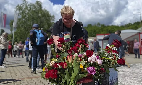 People arrive with flowers outside the F. D. Roosevelt University Hospital, where Slovak Prime Minister Robert Fico, who was shot and injured, is being treated, in Banska Bystrica, central Slovakia, Saturday, May 18, 2024. The man accused of attempting to assassinate Slovak Prime Minister Robert Fico made his first court appearance Saturday as the nation’s leader remained in serious condition recovering from surgery after surviving multiple gunshots, Slovak state media said. (AP)