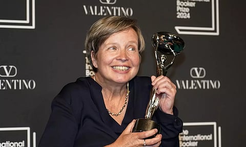 Jenny Erpenbeck, author of 'Kairos', holds the trophy after winning the International Booker Prize, in London (AP)