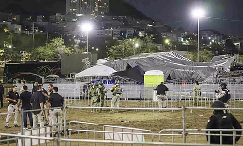 Security forces stand around a stage that collapsed due to gust of wind (AP)