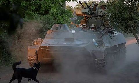 Ukrainian personnel in an armoured carrier after Russia's attack on Ukraine (Reuters)