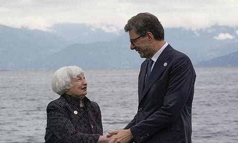 United States' Treasury Secretary Janet Yellen shakes hands with Italy's Finance Minister Giancarlo Giorgetti as she arrives at the G7 Finance Ministers meeting in Stresa, northern Italy (AP)
