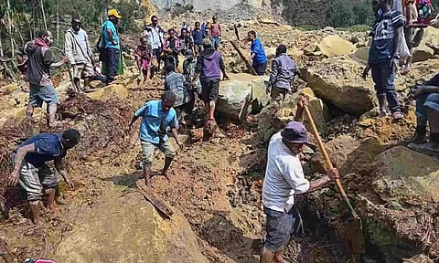 Villagers search through a landslide in Yambali, in the highlands of Papua New Guinea (AP)