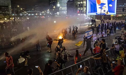 Police use water cannon to disperse demonstrators during a protest against Israeli Prime Minister Benjamin Netanyahu's government (AP)