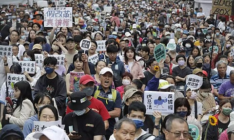 Supporters for both ruling and opposition parties demonstrate at the legislative chamber building in Taipei (AP)