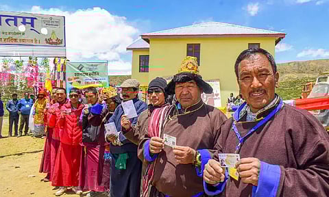 Voters wait in a queue to cast votes for the seventh and last phase of Lok Sabha polls at the world's highest polling station, in Tashigang, Lahaul and Spiti