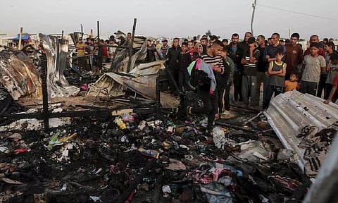 Palestinians look at the destruction after an Israeli strike where displaced people were staying in Rafah, Gaza Strip (AP)