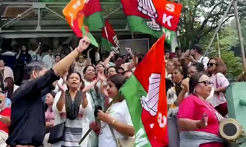 Sikkim Krantikari Morcha (SKM) members celebrate their lead in the Assembly polls, outside a counting centre, in Gangtok (PTI)
