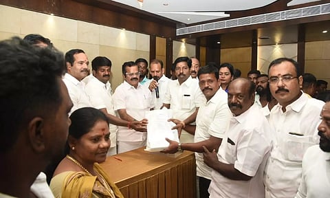 C Vijaya Baskar, AIADMK former minister, handing over identity cards to counting agents in Tiruchy on Monday