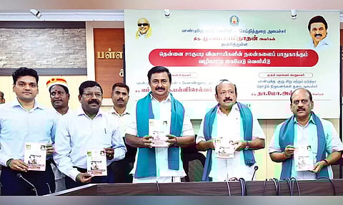 Minister MRK Panneerselvam along with other ministers releases a handbook for the welfare of coconut farmers at the secretariat on Friday