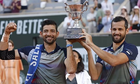 Marcelo Arevalo, of El Salvador, and Mate Pavic of Croatia celebrate with the trophy as they won the men's doubles final match of the French Open tennis tournament&nbsp;