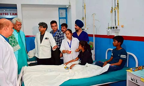 Jammu and Kashmir Lieutenant Governor Manoj Sinha meets the injured pilgrims at a hospital (PTI)&nbsp;