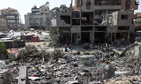 People walk among debris, aftermath of Israeli strikes at the area, where Israeli hostages were rescued on Saturday (Image/Reuters)
