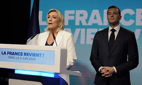 French far-right leader Marine Le Pen delivers a speech as Jordan Bardella, president of the French far-right National Rally&nbsp;