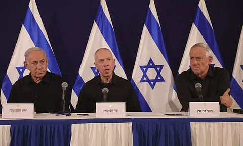 Israeli Prime Minister Benjamin Netanyahu, Defense Minister Yoav Gallant and Cabinet Minister Benny Gantz speak during a news conference in the Kirya military base in Tel Aviv