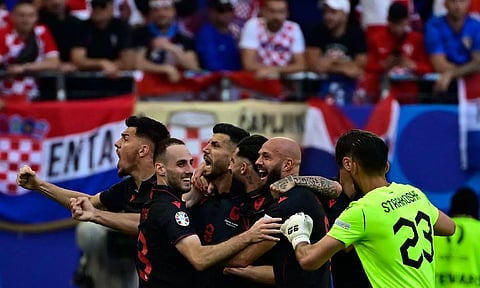 Albania’s Klaus Gjasula celebrates with teammates after scoring the equaliser in 90+5 minutes