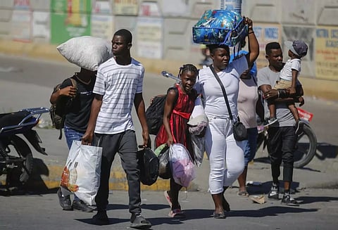 Residents of the Solino neighbourhood who were displaced from their homes due to clashes between armed gangs seek shelter as they walk along a street in the Carrefour community of Port-au-Prince in Haiti on January 18, 2024. (AP File Photo)
