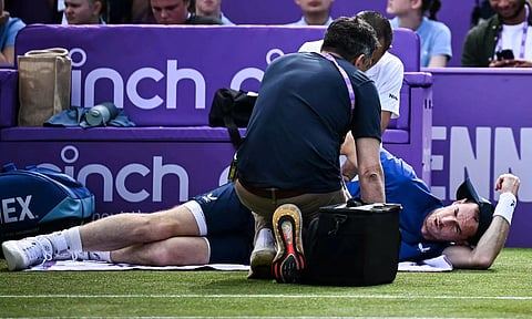 Andy Murray receives medical treatment on the court during ATP Championships at Queen’s Club