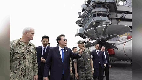 South Korean President Yoon Suk Yeol, third from left, boards the USS Theodore Roosevelt aircraft carrier at the South Korean naval base in Busan, South Korea (Photo/AP)