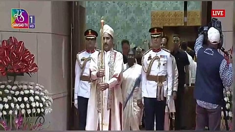 Parliament official carries Sengol as President Droupadi Murmu leaves from Lok Sabha (Photo/Sansad TV)